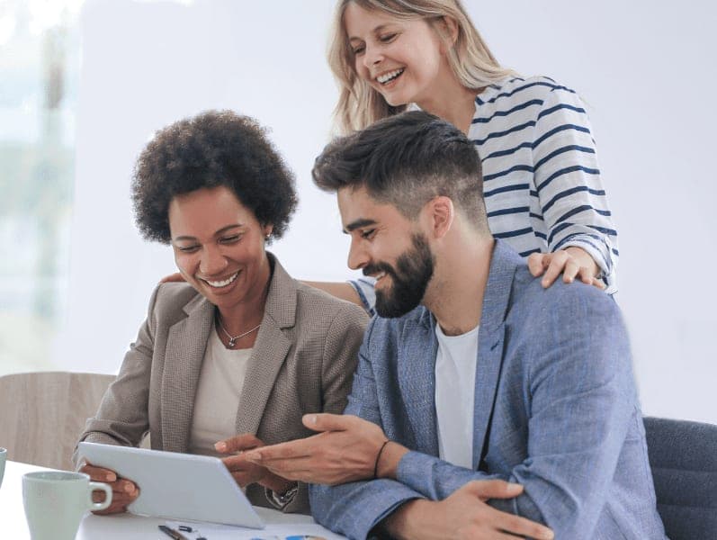 Close up of three people working in an office