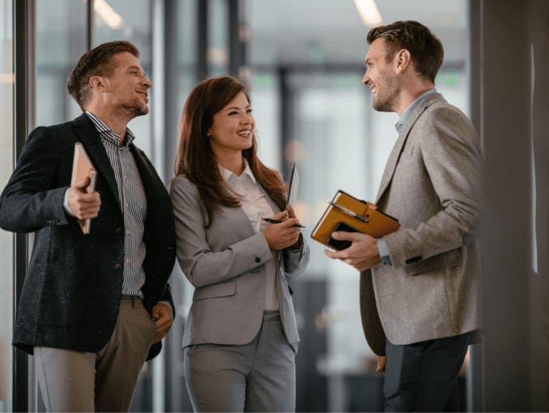 Happy colleagues having a conversation in the office