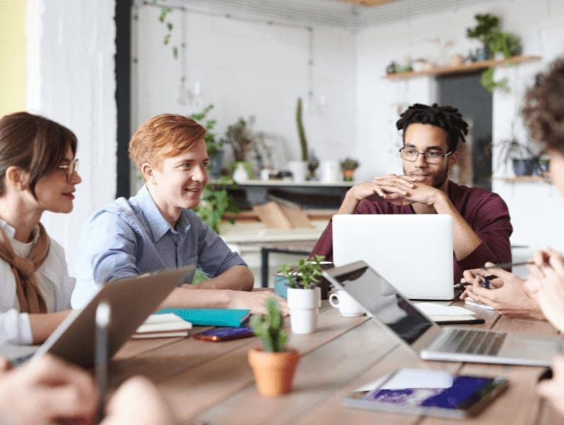 Group of employees working together in a modern office.
