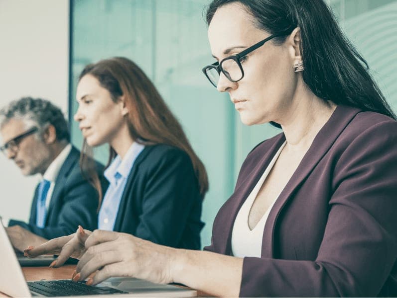 Business people sitting in line and using laptop in office.