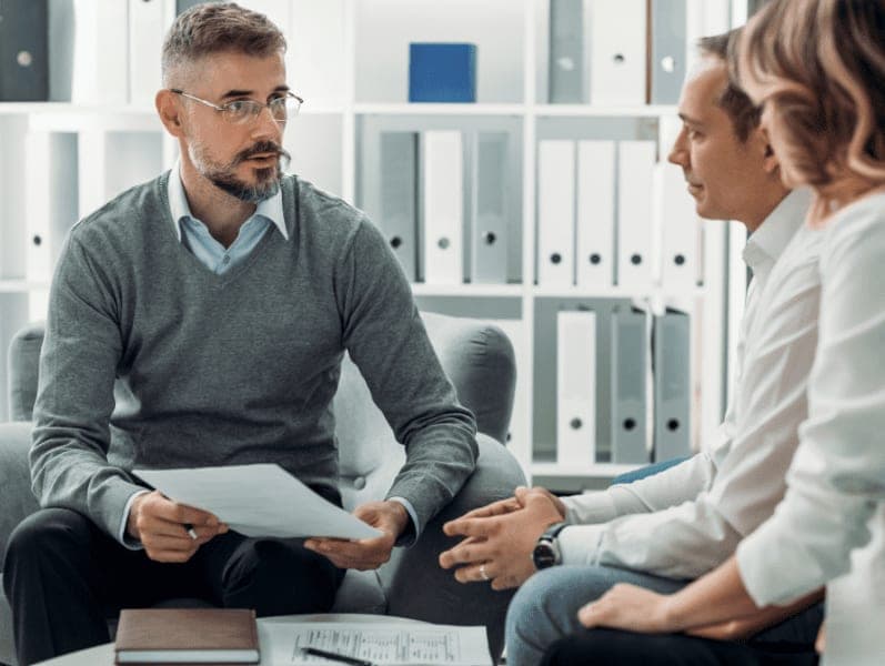 Financial advisor discussing reports to his clients.