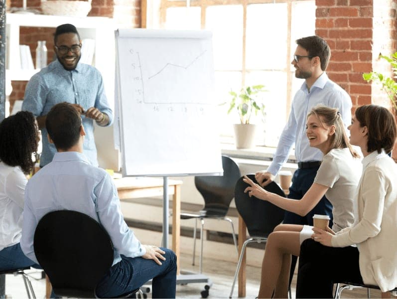 Coworkers laugh having fun at casual briefing.