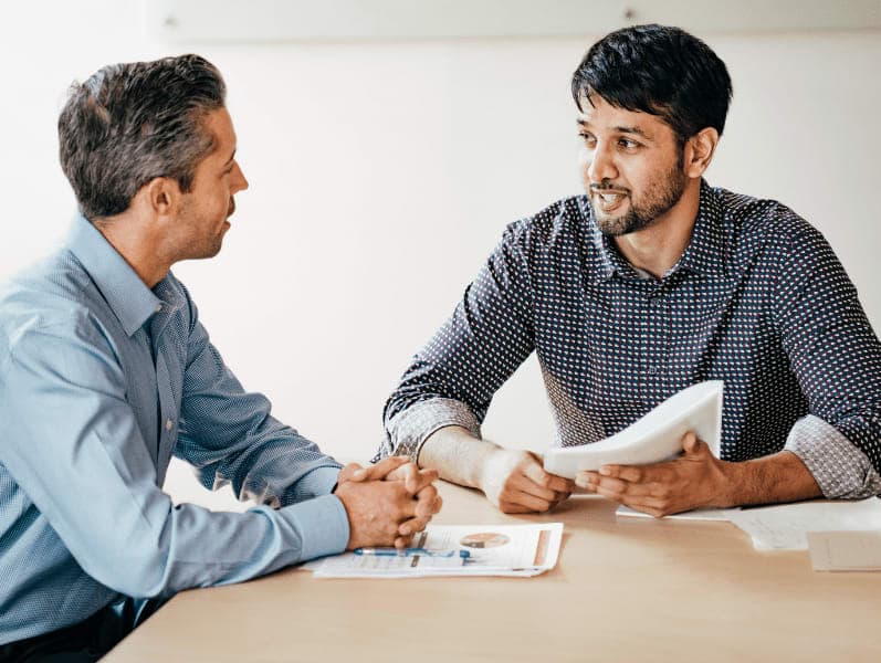 Two people talking in the office.
