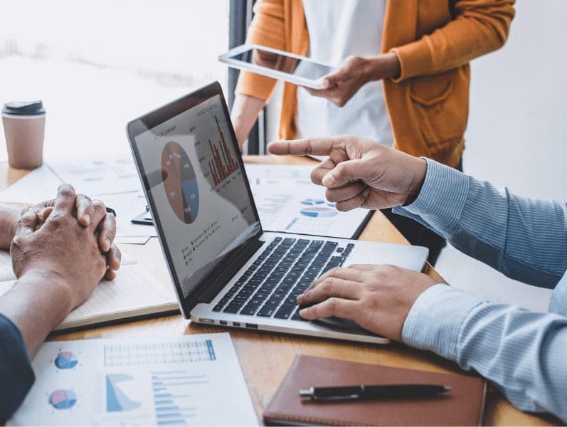 Businessman explaining his idea concepts to coworkers with charts and graphs.