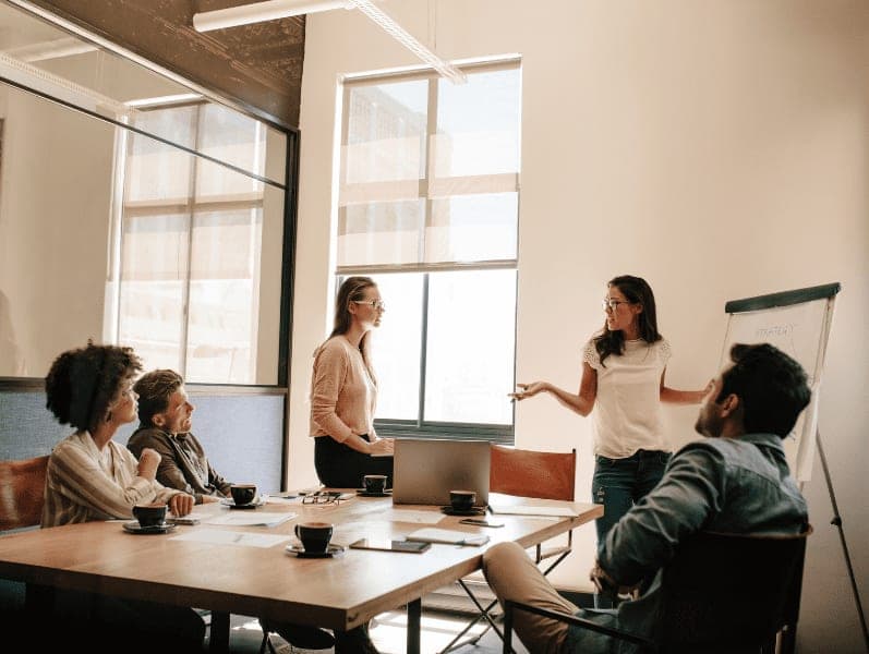 Creative business team having discussion during presentation in conference room.