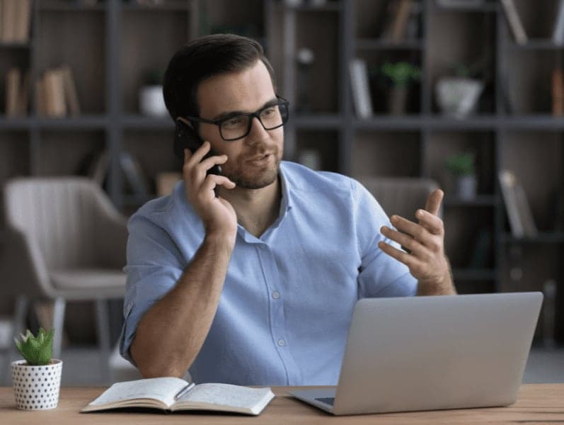 Young professional giving advice to client by phone. 