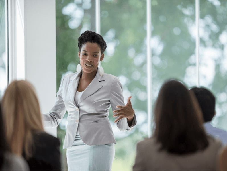A woman is presenting on their business concepts.