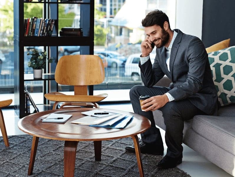 Young businessman talking on a cellphone in a modern office.