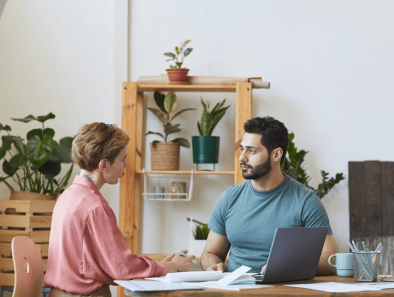 Employee talking to HR manager in the modern office.