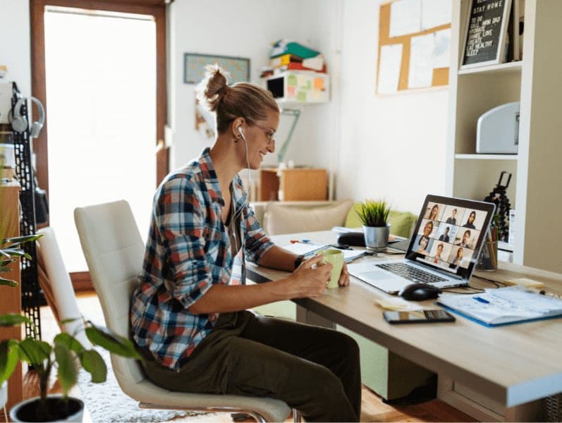 Woman at home having video conference with colleagues.