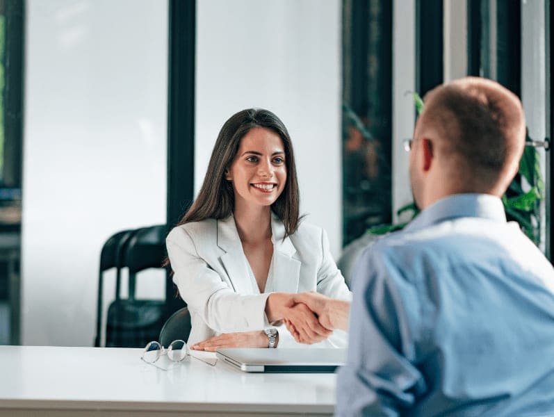 Female HR manager greeting job candidate.