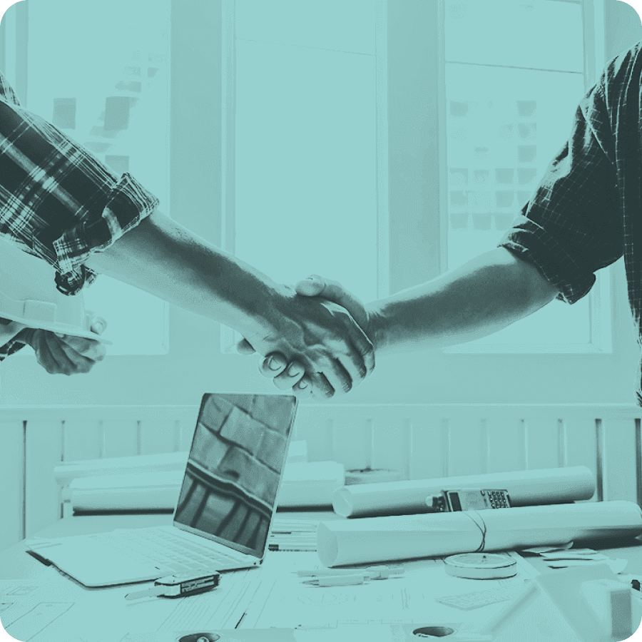 Closeup of a handshake above a workstation