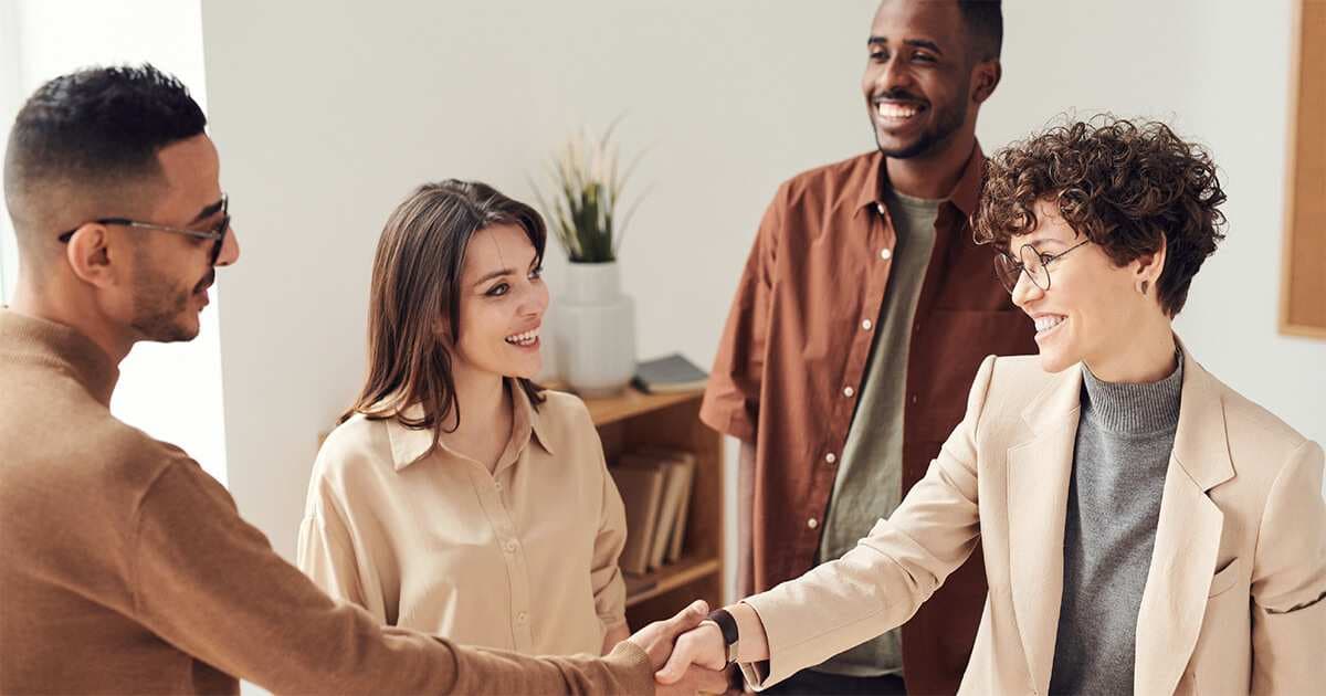 A group of people stand together at work