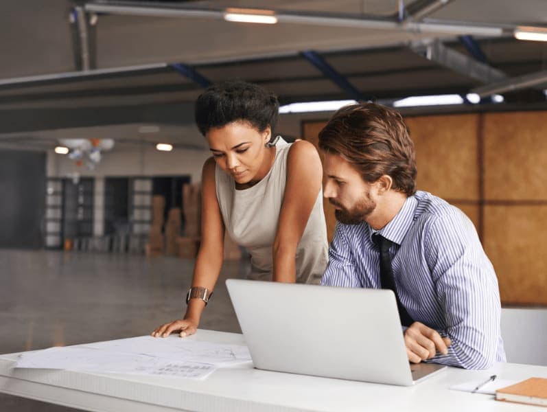 Male and female employee reviewing clients time sheet