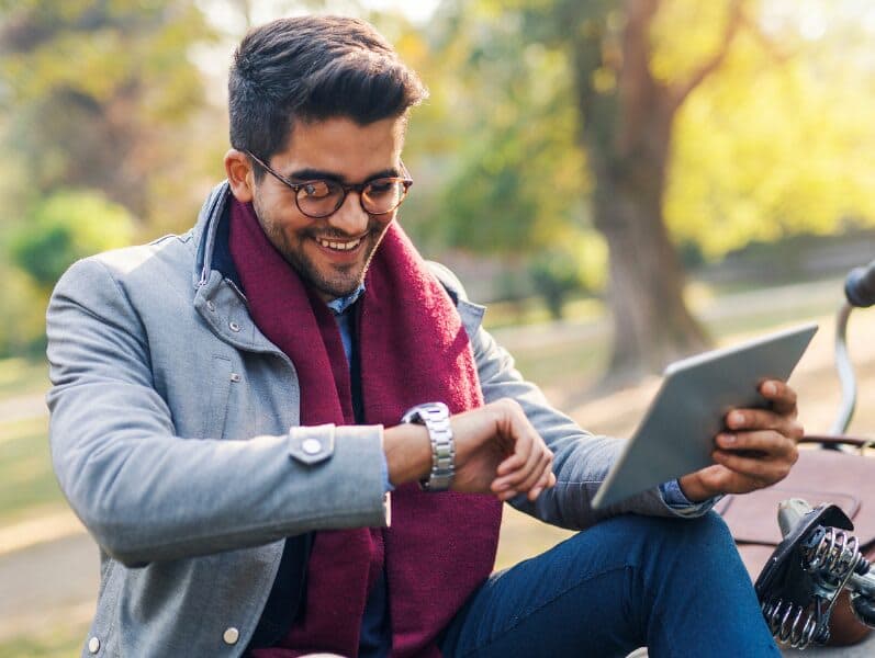 Man sitting out site refencing the time