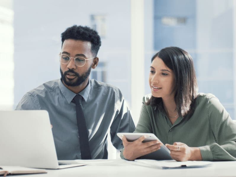 Colleagues walking through technology to onboard a client