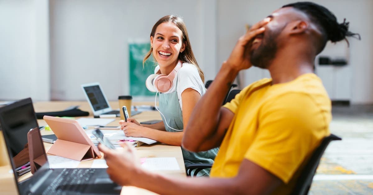 Co-workers having fun while working in a office.