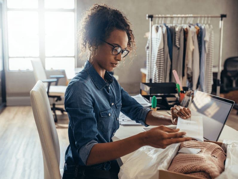 Female entrepreneur preparing a package for delivery