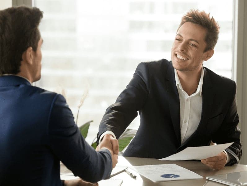 Smiling businessman and client handshaking