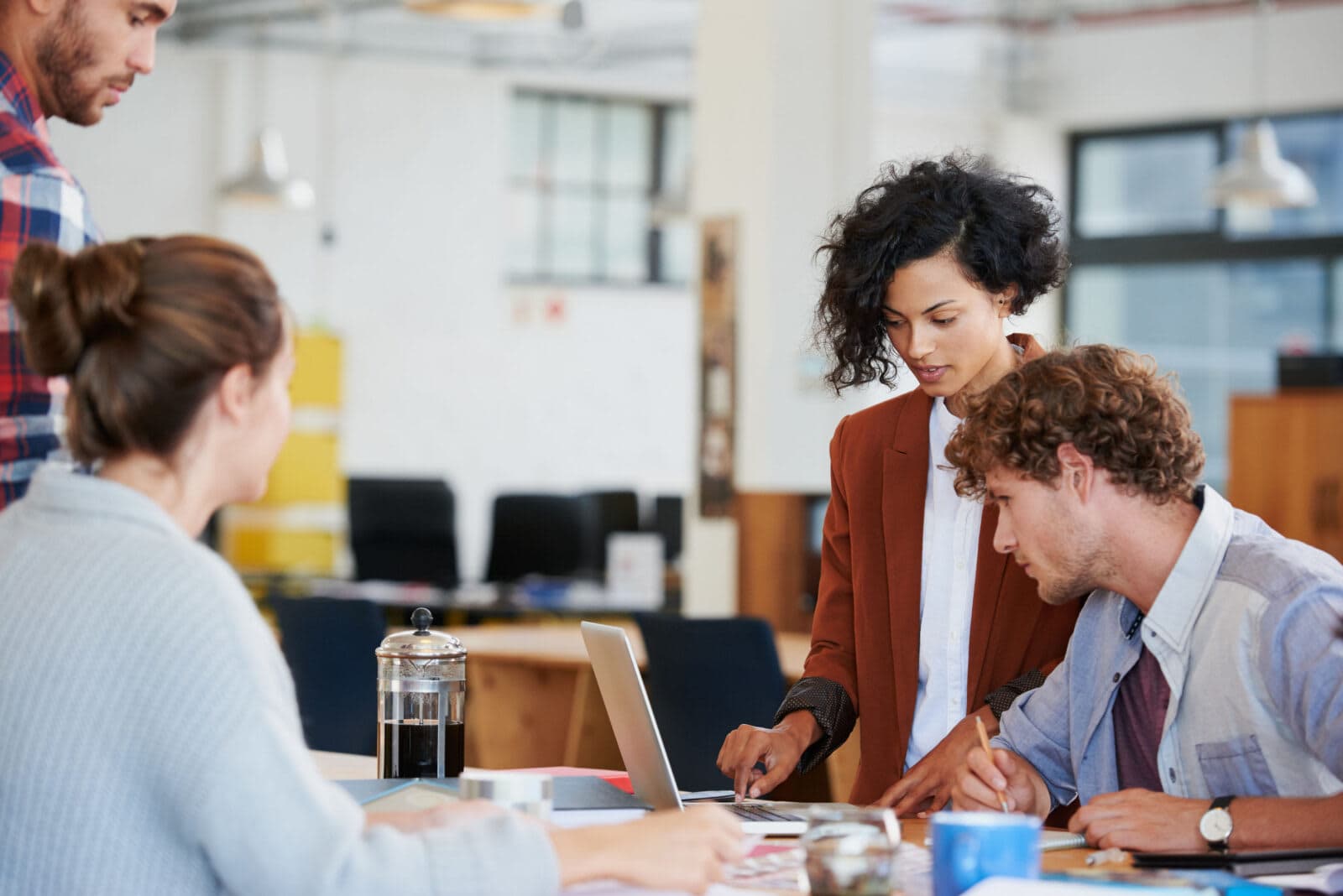 Group of young professionals working on a creative project in a startup