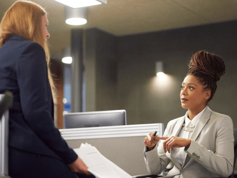 Female accounting manager giving feedback to a female accountant.