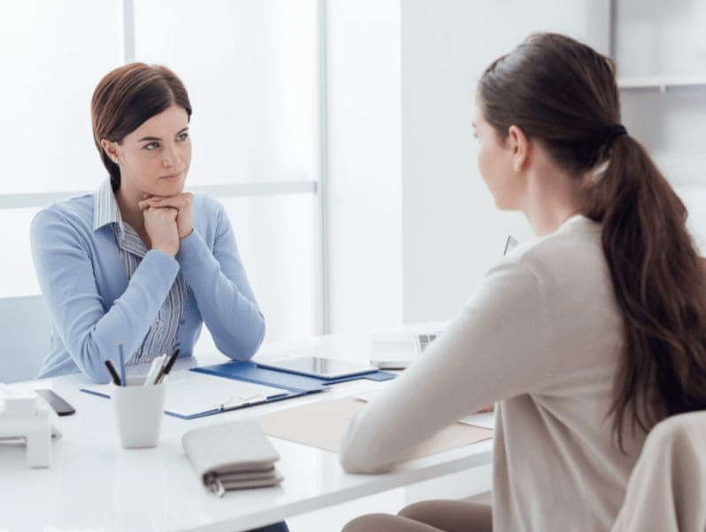Female accounting manager having a conversation about deadlines with a female accountant.