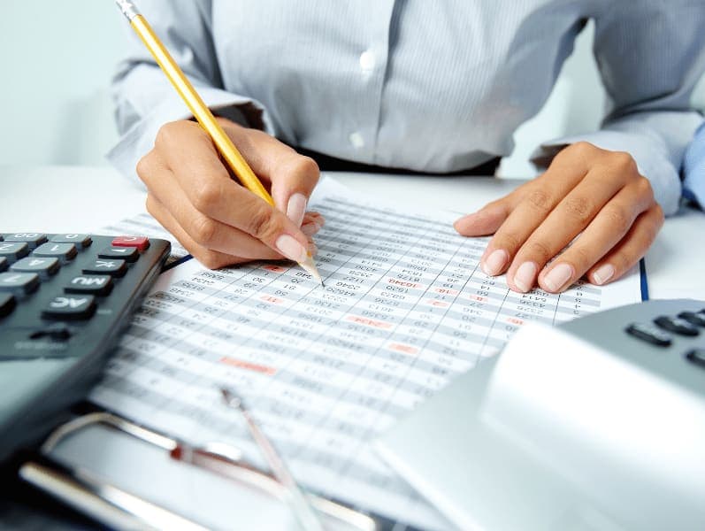 Female sitting her desk reviewing blockchain numbers for a client