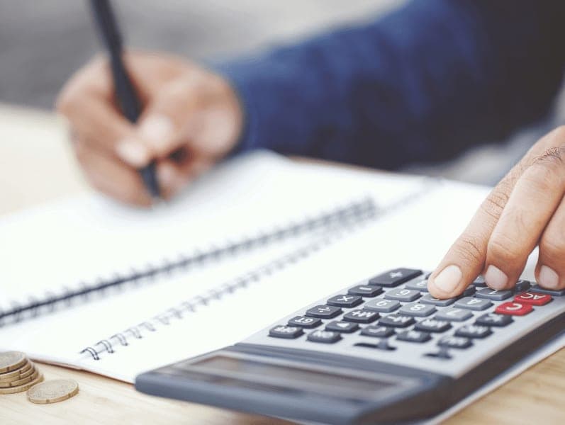 Man sitting at his desk calculating his blockchain numbers