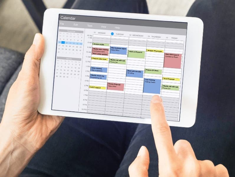 Accountant referring to google calendar to review his time set for the week