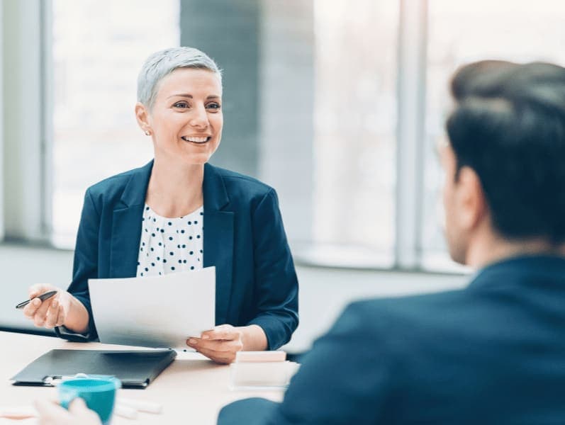Female sitting across from male colleague discussing growth potential