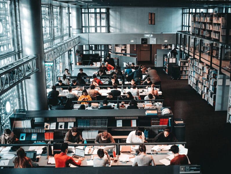 Two story open space library with students studying below for exams