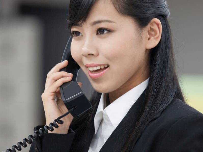 Young female accountant following up with a potential client via telephone.