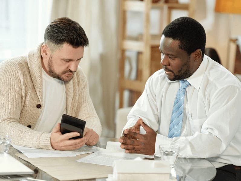 Male accountant advising a male small business owner.