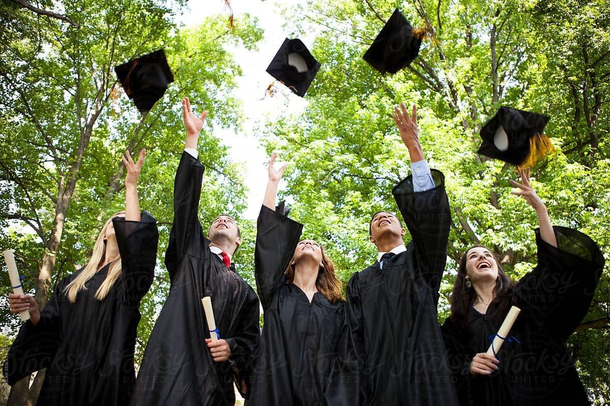 New graduates throwing their graduation caps in the air