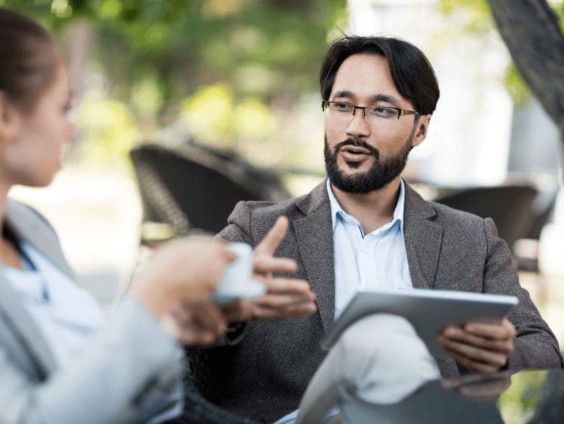 Young businessman talking to co-worker.