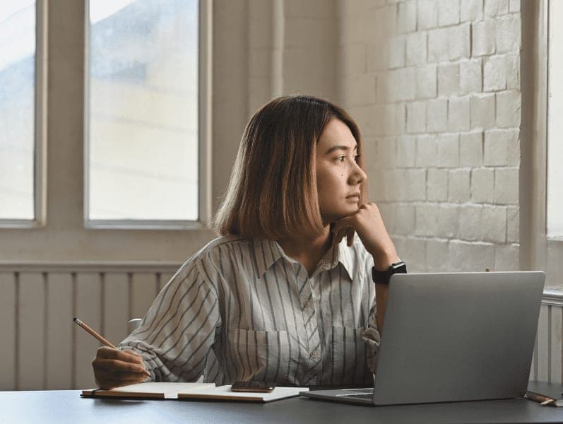 Female thinking ideas with looking on windows.