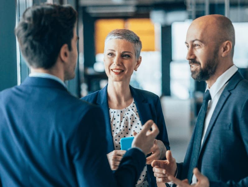 Businessman and business woman talking at the office corridor.