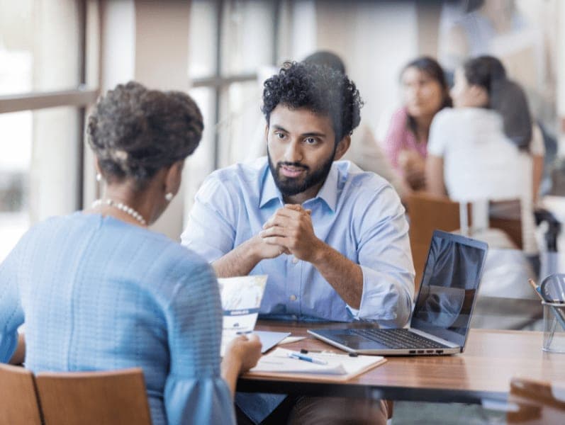 Male bank employee explains the loan application process.
