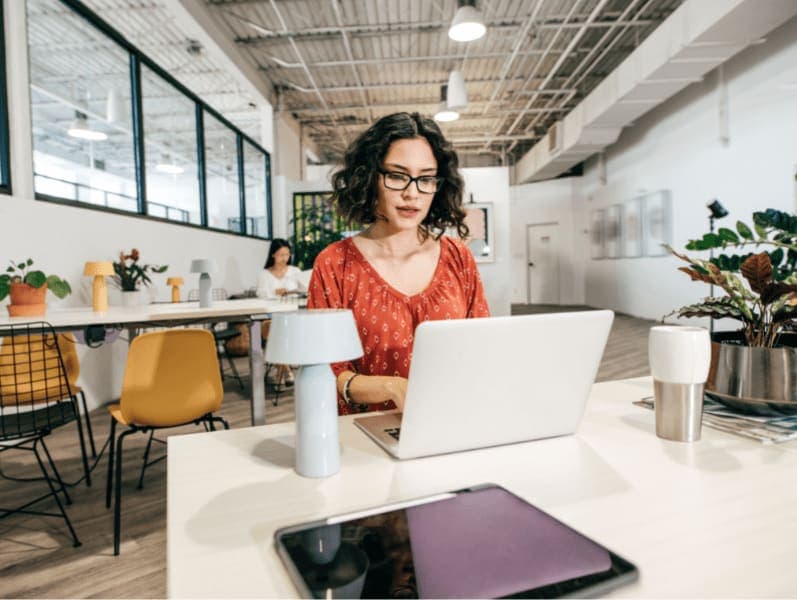Woman working with online clients in a modern office.