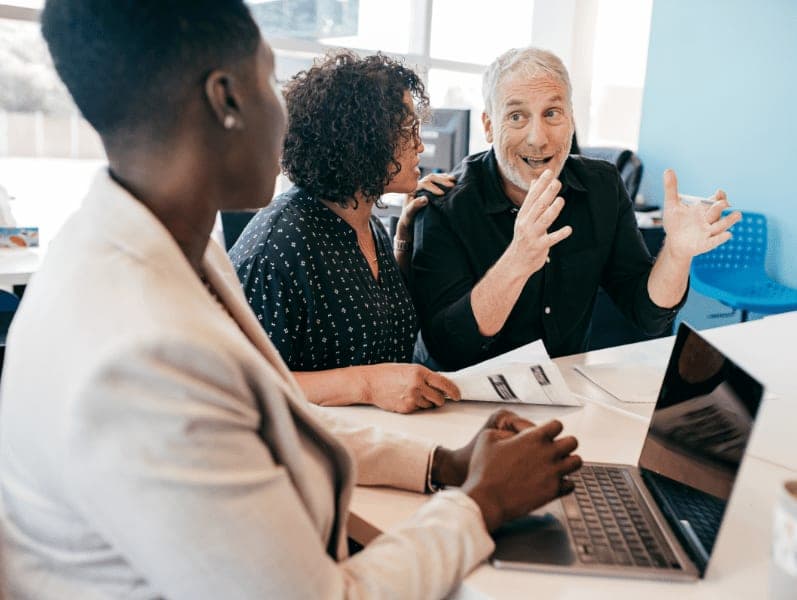 Middle-aged couple having a meeting with insurance agent in the office.
