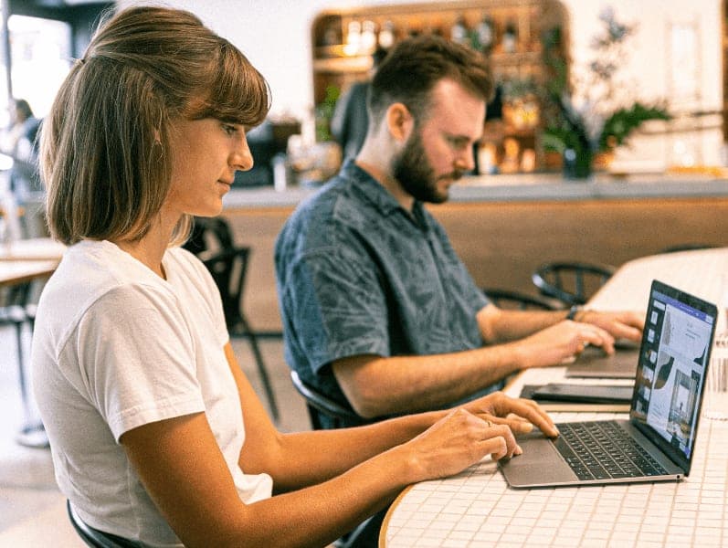 Woman using a laptop in a café.