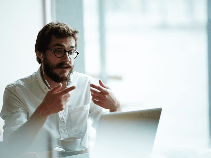 Businessman explaining to client during online meeting.