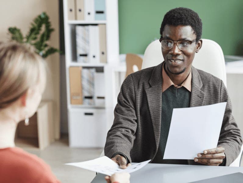 HR manager taking a resume from the employee during business interview at office.