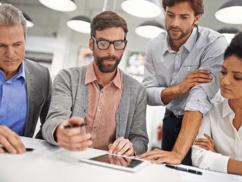 Male office worker giving explanation to co-workers.