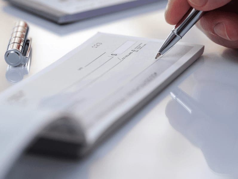 Businessman prepare writing check in the office.