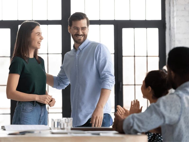 Promoted employee receive congratulations from company staff