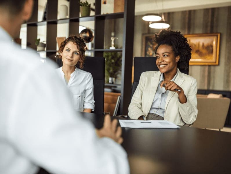 Two business woman sitting at modern office for meetings