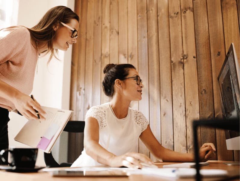 Businesswomen working together on project at modern startup office