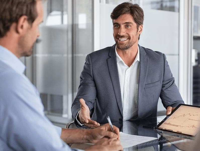 Confident advisor showing growth graph to client