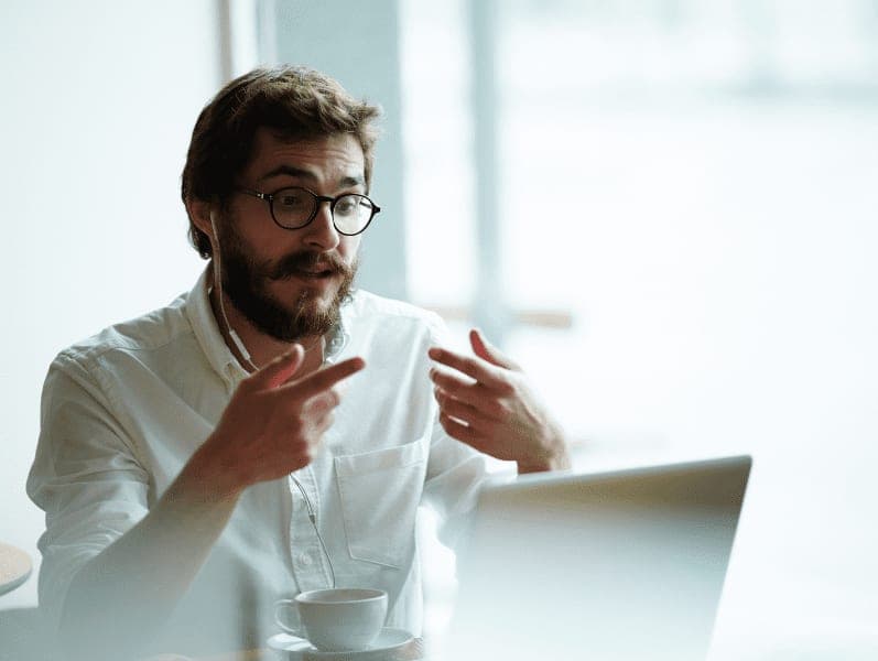 Young accountant communicating with client through video chat